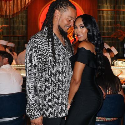 Aja Crowder is posing on her black dress as Channing Crowder is wearing a shirt and has his eyes closed in the picture.